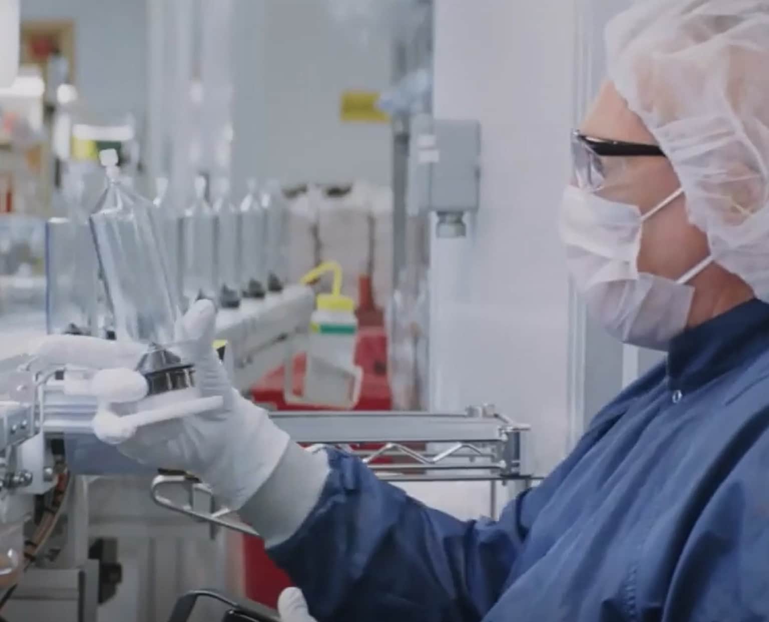 A researcher carefully operating an injector system