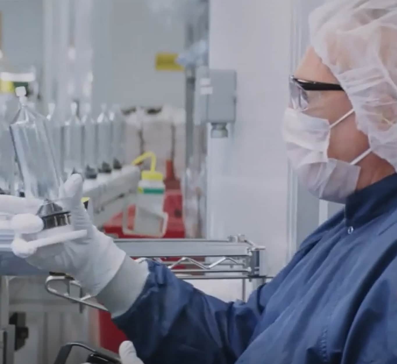 A researcher carefully operating an injector system